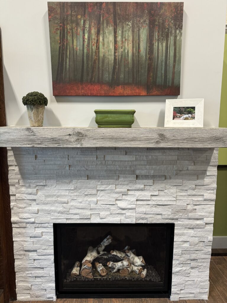 Mendota FV36 Traditional Direct Vent Gas Fireplace with Realstone Systems White Birch Ledgestone and a 5ft MagraHearth noncombustible mantel from their Natural Wood collection in a White Washed finish.